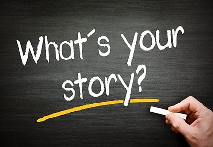 A chalkboard with the words " what 's your story ?" written on it.