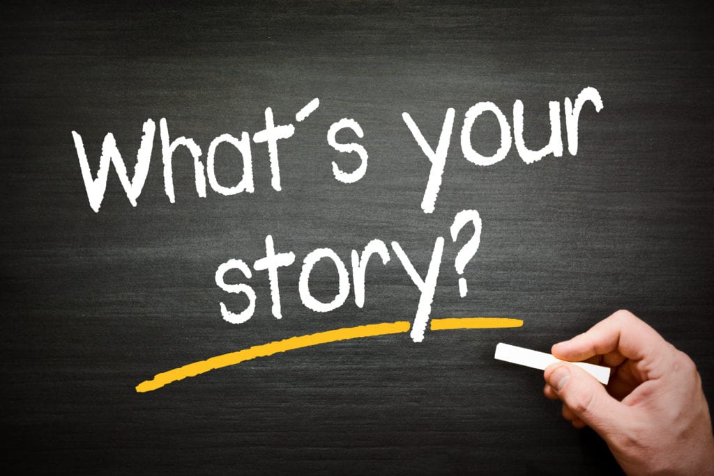 A chalkboard with the words " what 's your story ?" written in chalk.